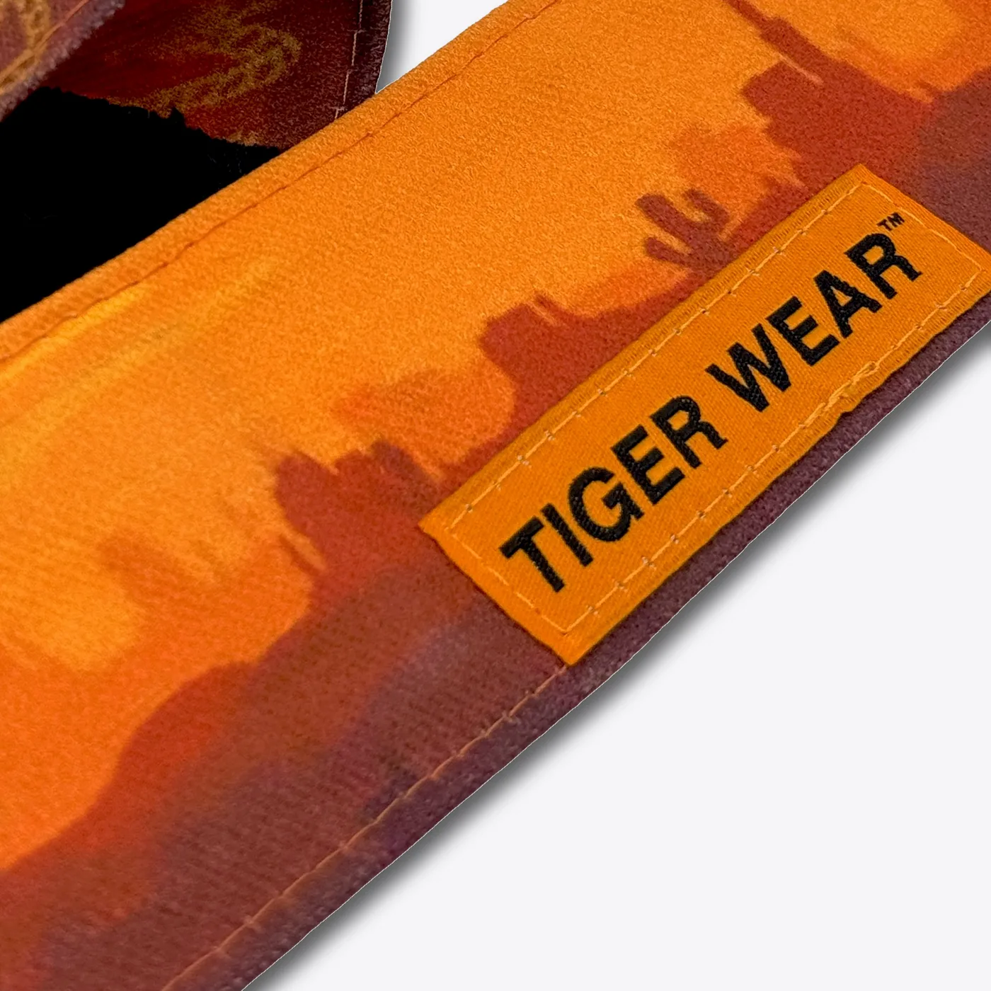 Close up of the High Noon headband: the desert print and the stitched Tiger Wear patch