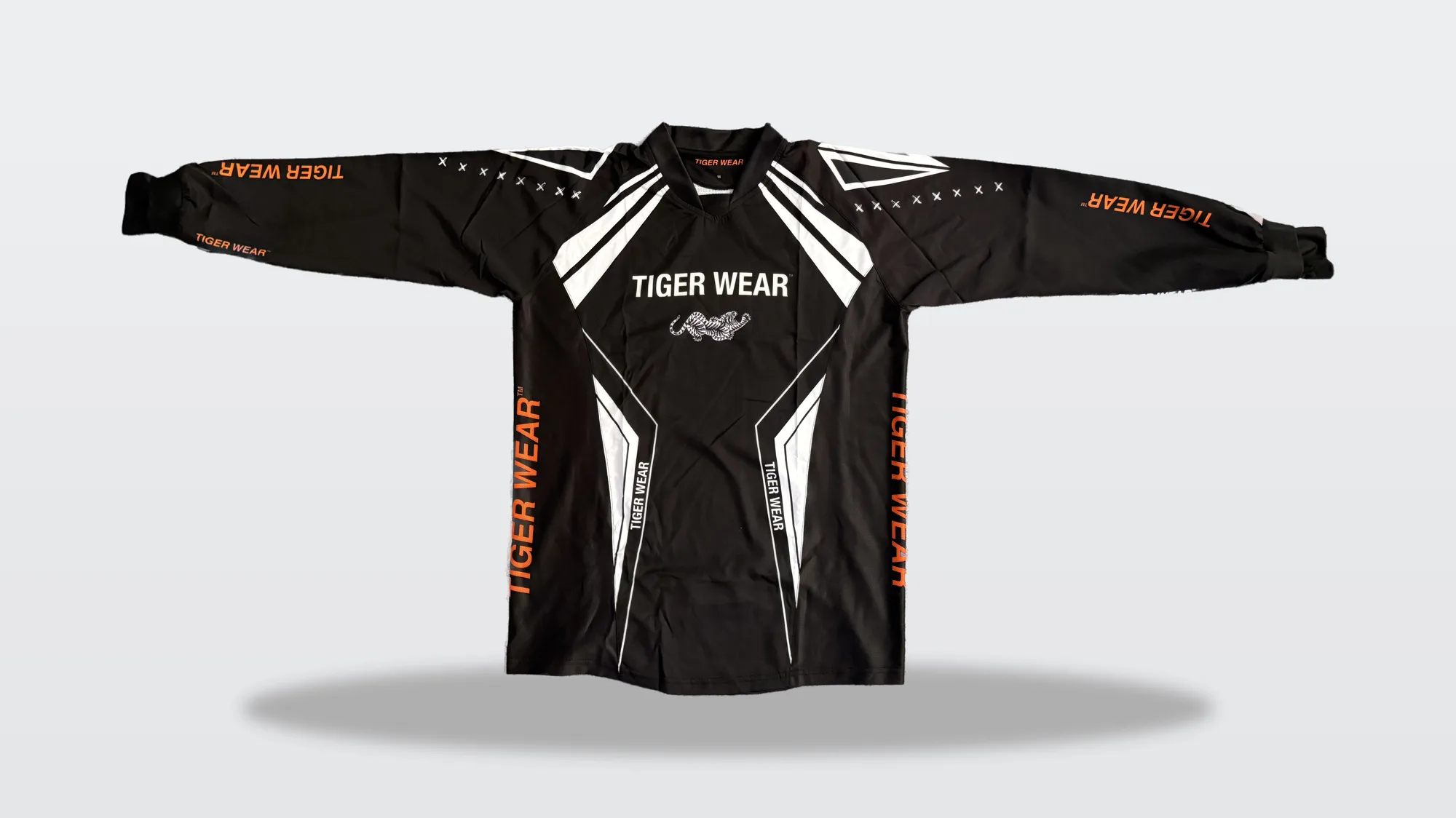 The Athletics Practice Pro jersey laid flat: black with white and orange sleeve panels